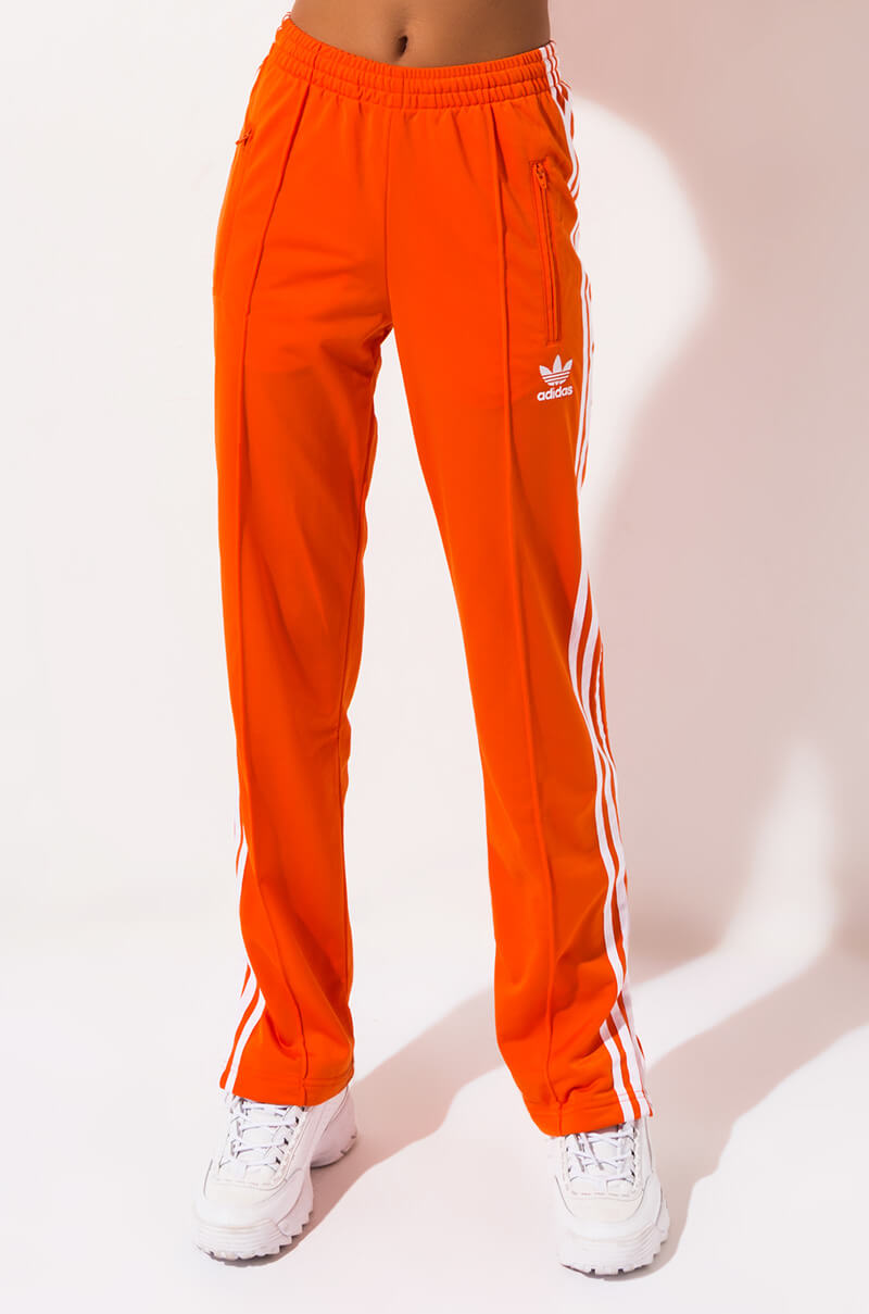 black adidas pants with orange stripes